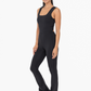 side view of the Venice twist back flare jumpsuit in the color black
