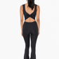 full length back view of venice twist back jumpsuit in the color black