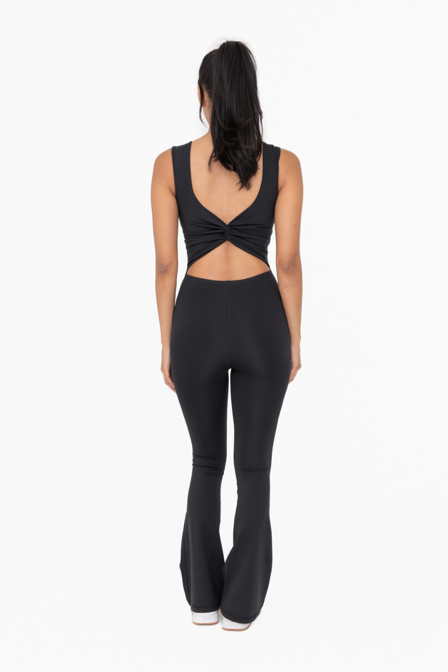 full length back view of venice twist back jumpsuit in the color black