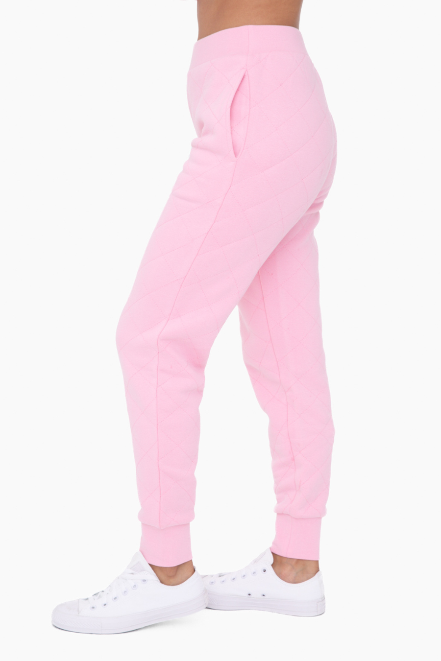 side and back view of the cotton candy high waisted joggers, model is wearing them with white tennis shoes 