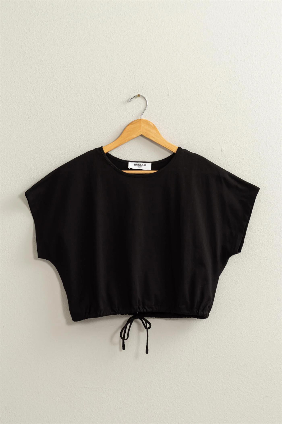 full length front view of Dakota crop top in the color black, having of hanger 