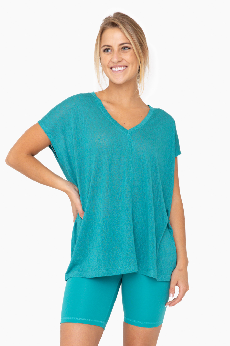 close up front view  of the mina top in the color teal 