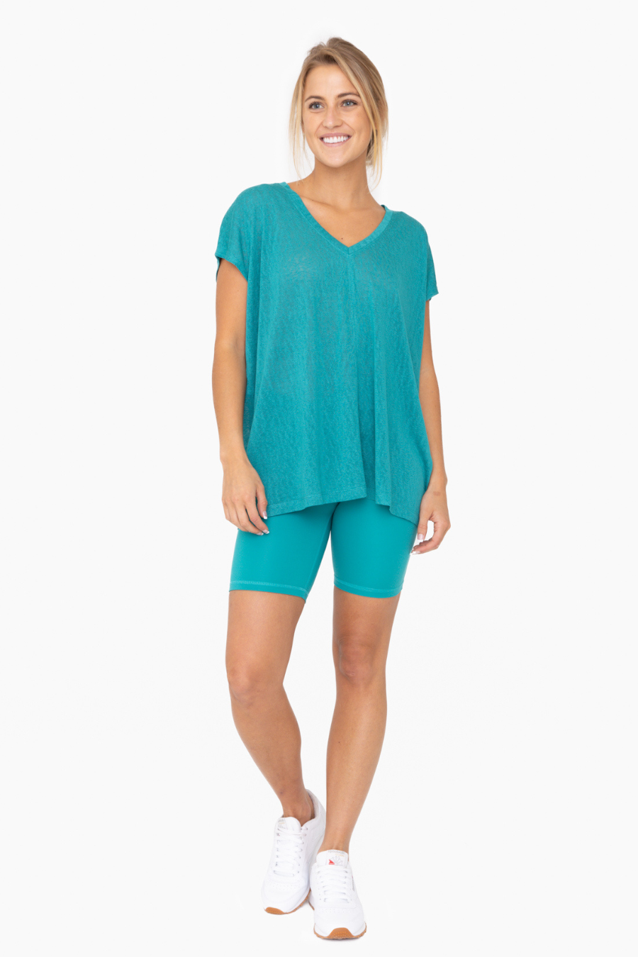 full length view of the mina top in the color teal, paired with matching shorts
