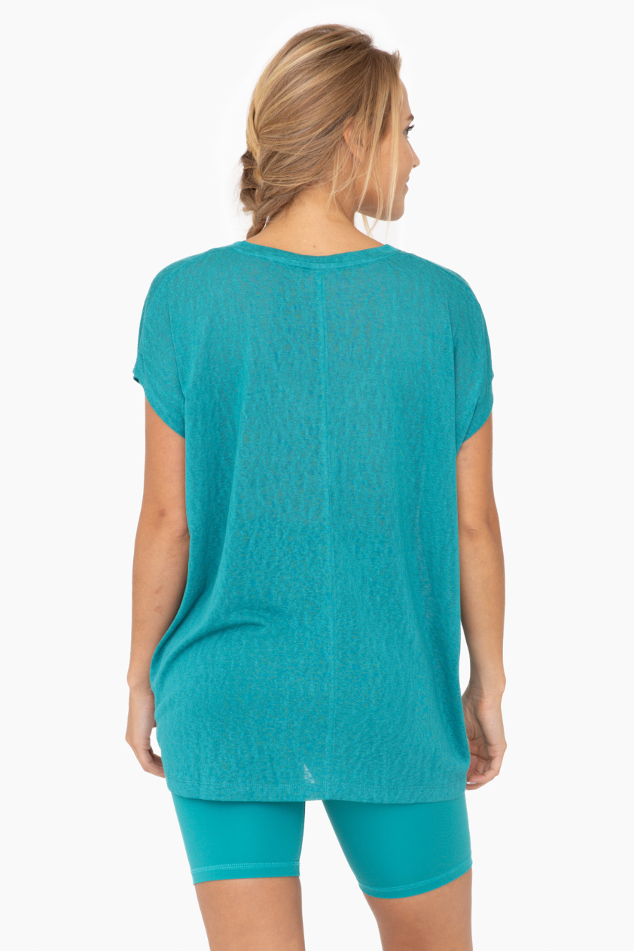close up back view of the mina top in the color teal 