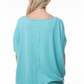 close up back view of capri boat neck short sleeve top in the color aqua, model is wearing top with white jeans