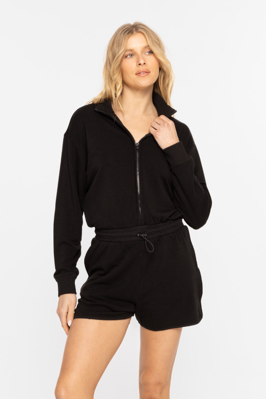 close up front view of long sleeve mock neck romper in black 