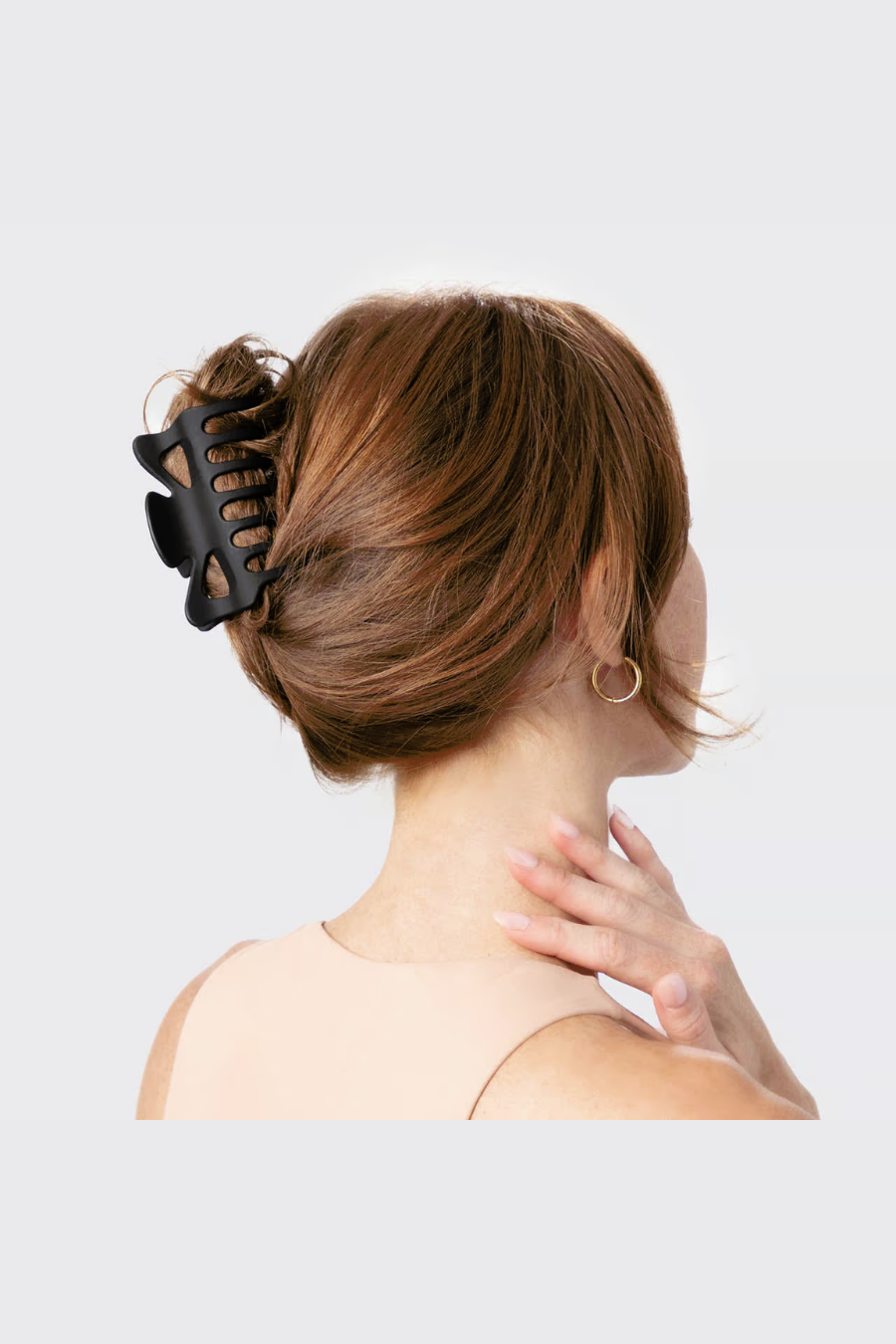 woman with hair up into black claw clip