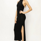 full length side view of girl wearing black Georgia halter dress with black heels 