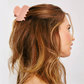 girl hair pulled back half up with pink claw clip