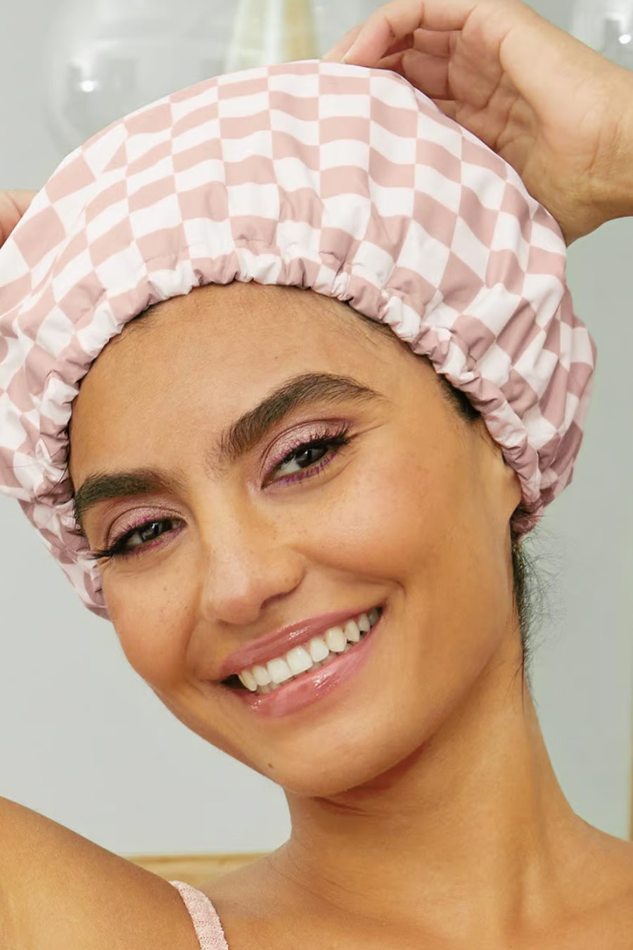 girl wearing blush checkered shower cap