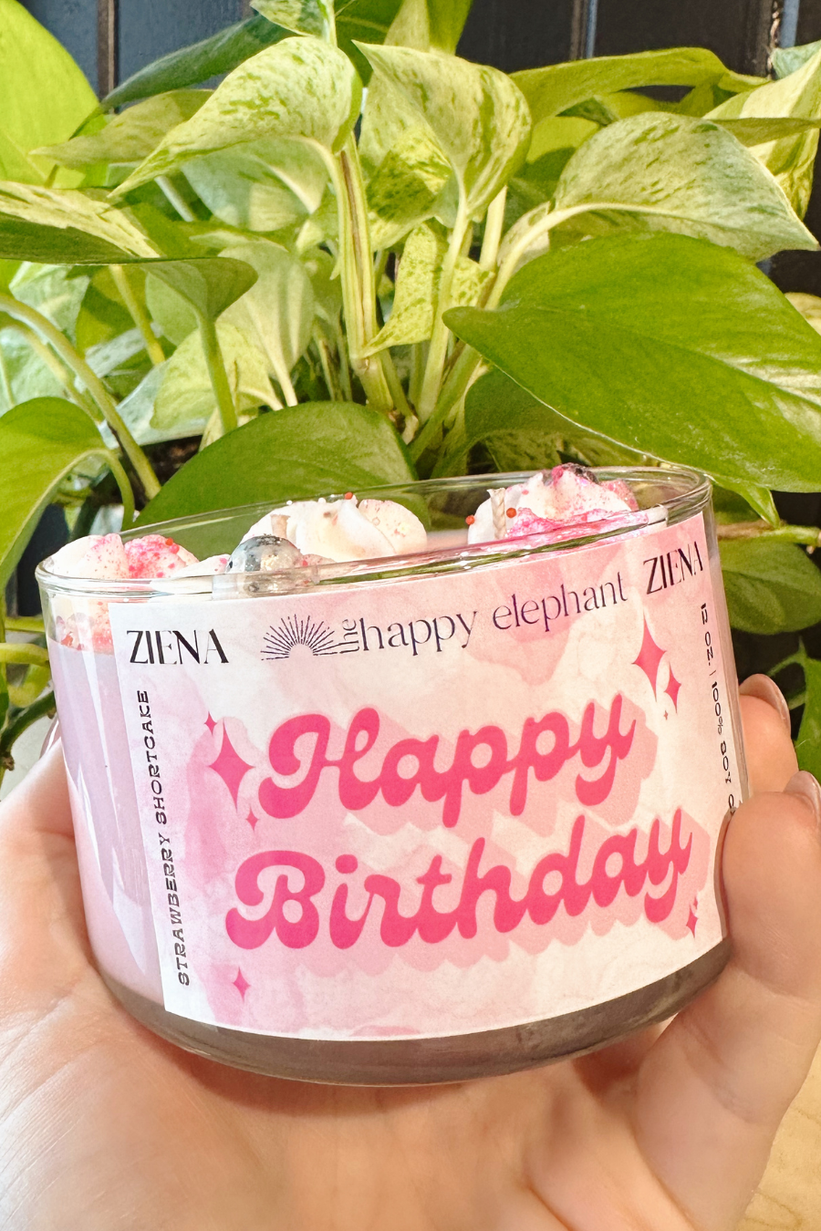 close up of happy birthday candle in hot pink writing 