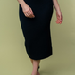 close up front  view of Juliana high waisted knit midi skirt in the color black . model is wearing it with heels 