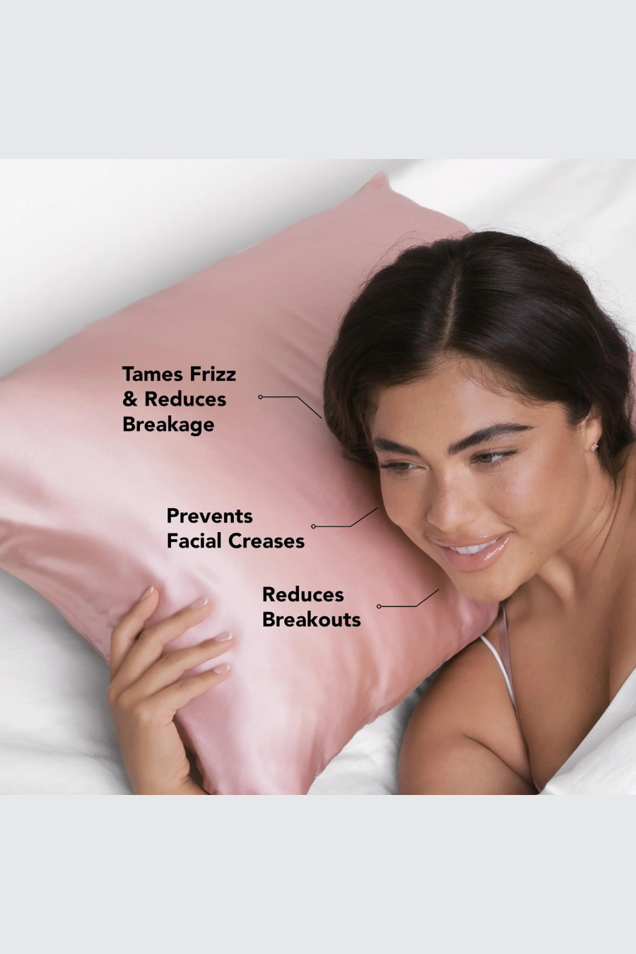 girl laying on satin pillowcase with the befits of the case are listed onto pillow 