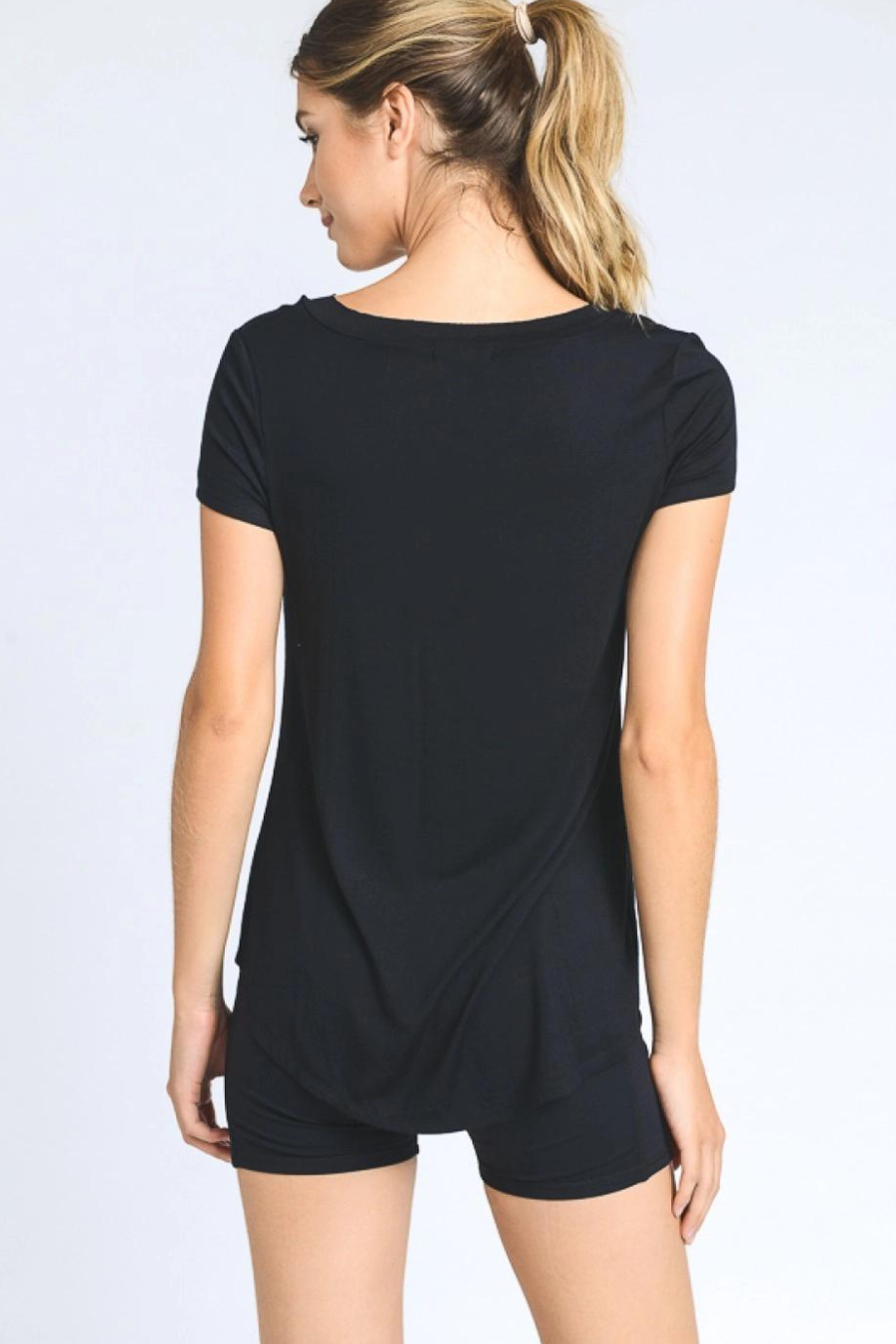 close up of the back of longline v neck everyday tee, model is wearing it with biker shorts 