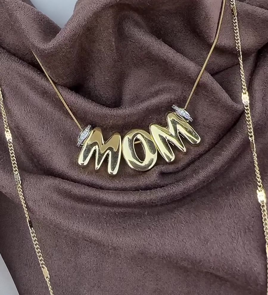 Gold bubble letters spelling MOM on a chain