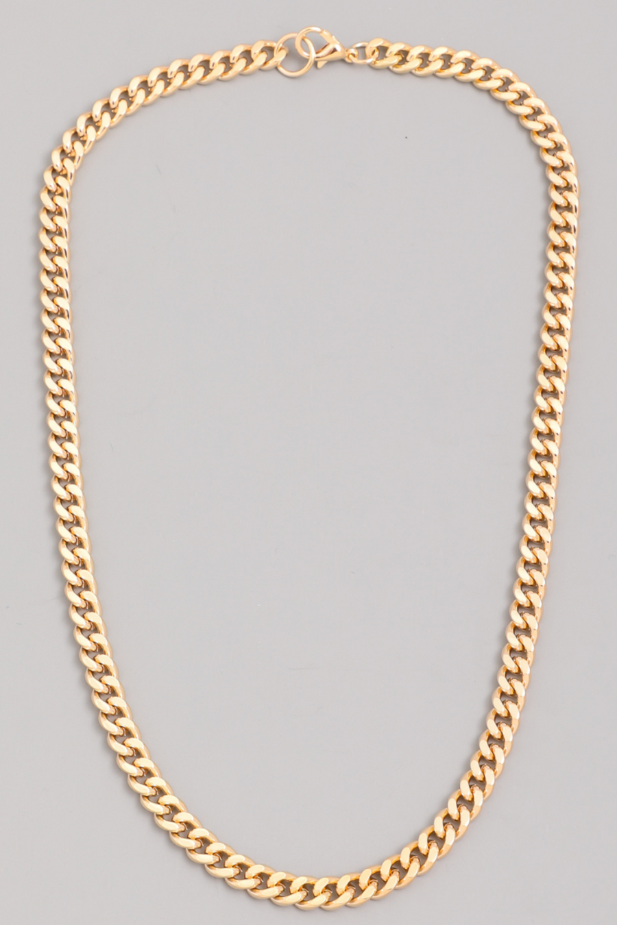 close up flat lay photo of gold link chain necklace 